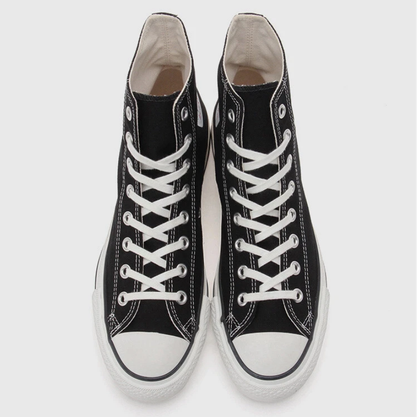 Black and white high-top canvas shoes